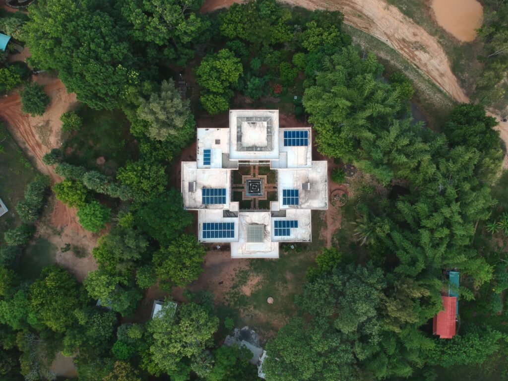 Eco-friendly home with solar panels surrounded by trees