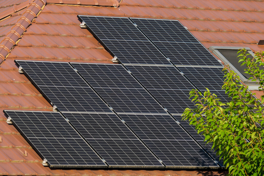 Row of solar panels on a red tile roof